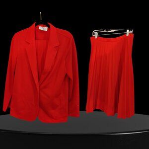 two-piece suit featuring a single-button blazer and a pleated midi skirt